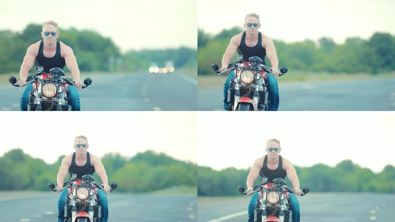 戴墨镜的男子气概摩托车手在高速公路上的摩托车上左转一个大而缓慢。特写肖像