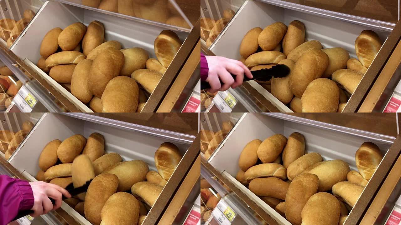 超市内散装食品区妇女选择面包的运动