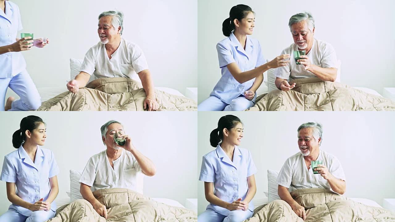 老人躺在床上，护士给他日常用药。卧室里的亚洲老人和美丽的亚洲护士。高级居家服务理念。