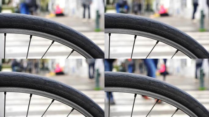 通过自行车车轮的辐条观察路人市民和城市居民