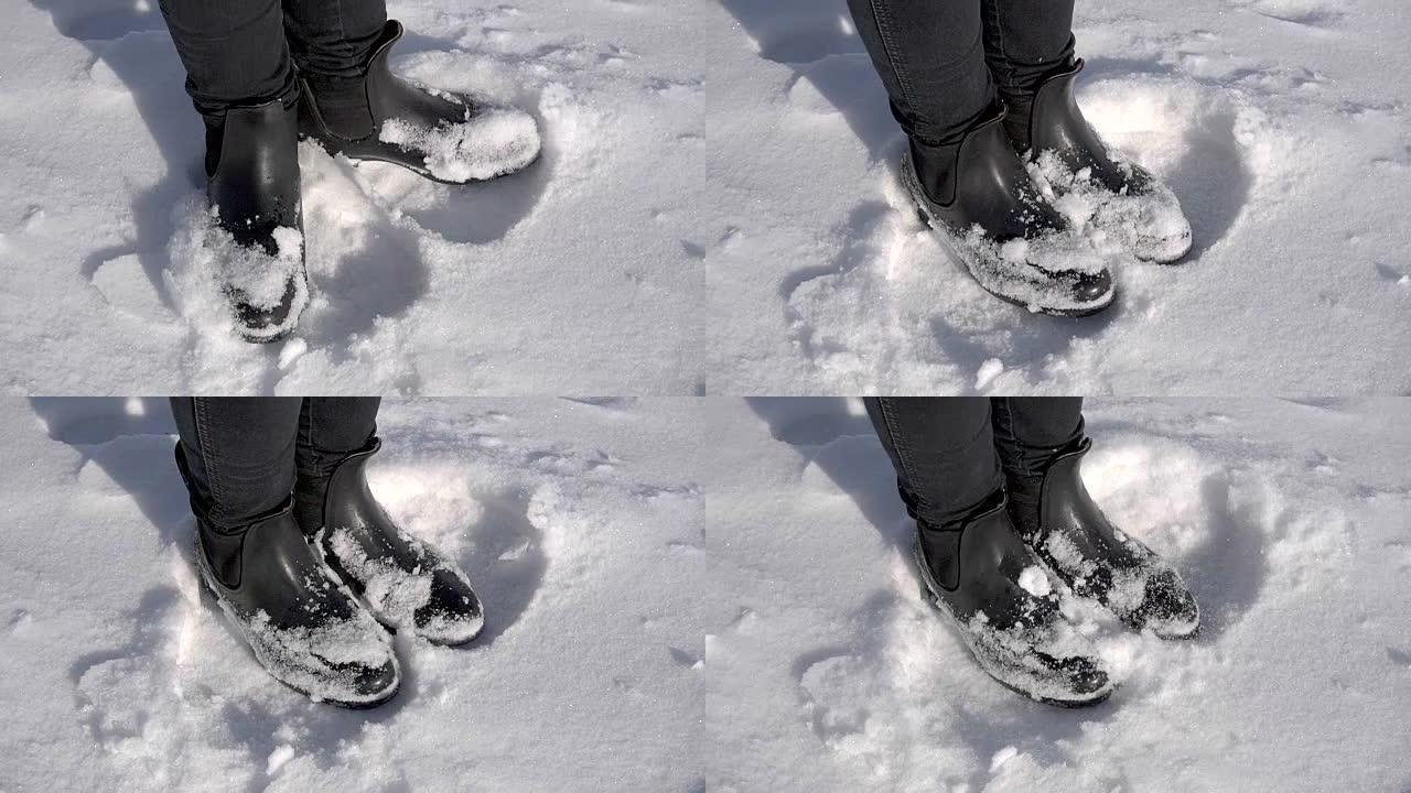 一个年轻女孩在雪地里的腿。那个女人在一个冰雪覆盖的冬季公园里冻僵了。