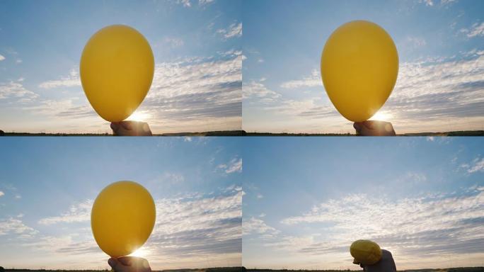 空气来自黄色的气球，它变得li行。在蓝天的背景下