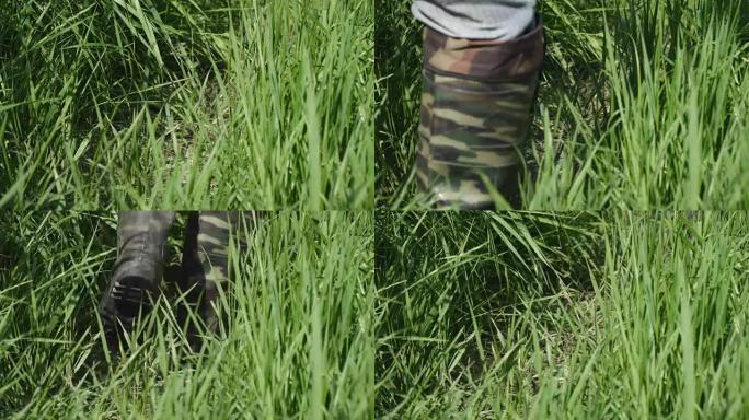 男子穿着保护色的卡其色靴子沿着茂密的草丛行走