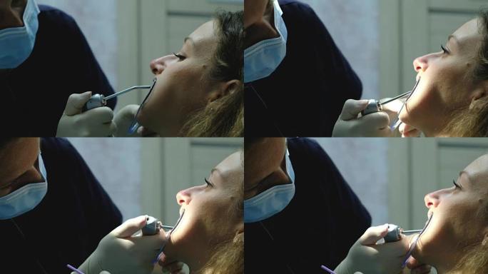口腔科医生在安装支架系统特写之前先干燥牙齿。拜访牙医正畸医生