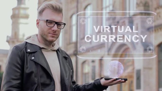 戴眼镜的聪明年轻人展示概念全息虚拟货币