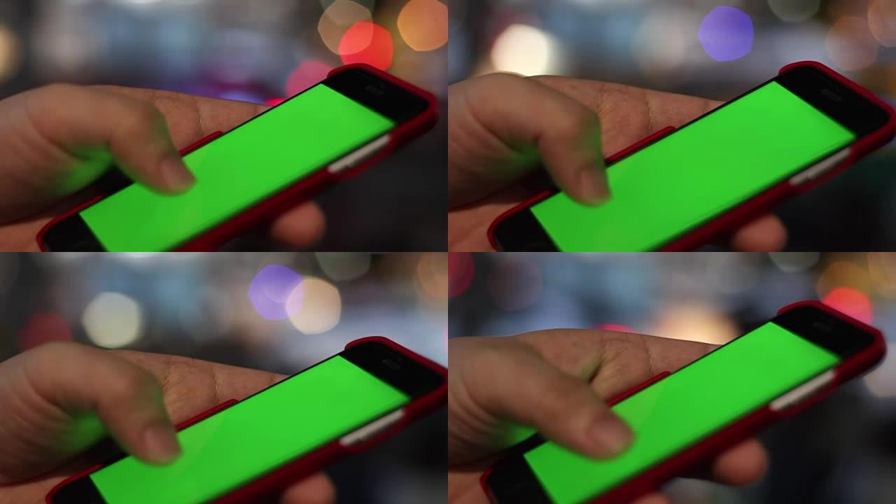 空白绿屏智能手机用手特写