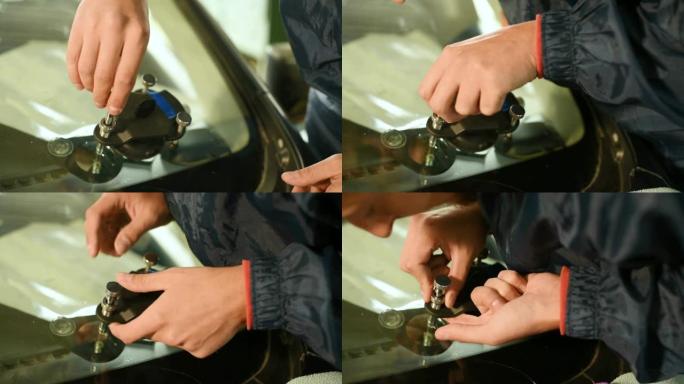 一个专业的人在车间从事消除汽车挡风玻璃上的裂缝的特写镜头。真空填充作业