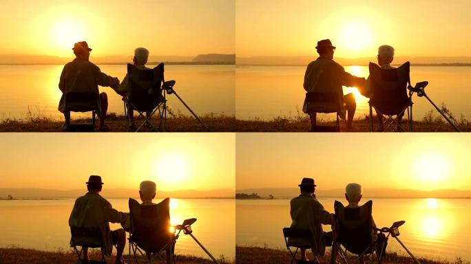 高级夫妇在湖边欣赏日落美景