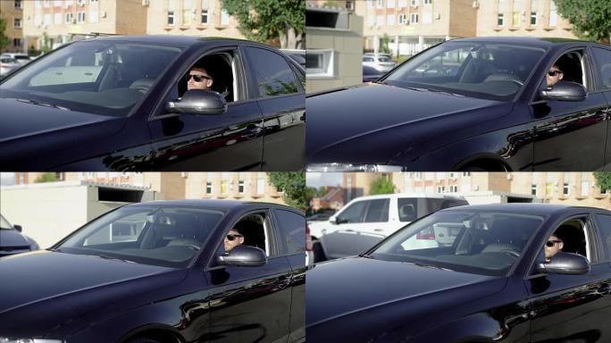 一名商人驾驶一辆干净闪亮的黑色汽车的镜头