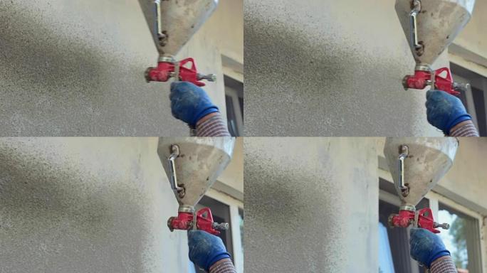 抹灰工程。石膏把砂浆喷在墙上。