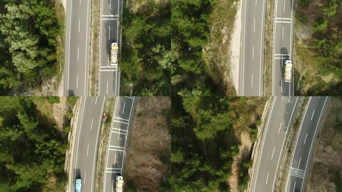 卡车行驶，在森林柏油路上行驶的航拍画面。公路卡车交通