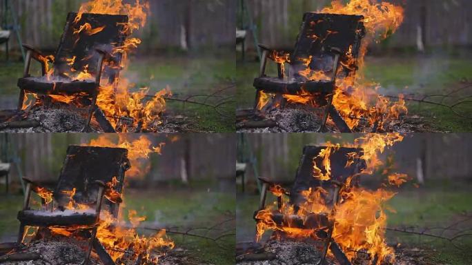 燃烧火并掉落旧的木制扶手椅