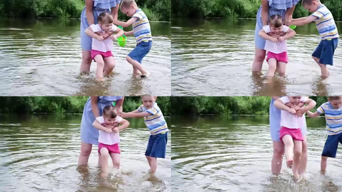 小女孩的母亲在河里洗脚。一个女人和她的孩子站在水里
