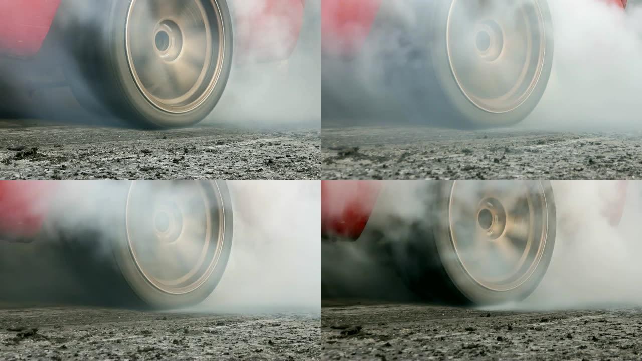 拖拉汽车使轮胎冒烟，赛车将轮胎上的橡胶烧掉，为比赛做准备。