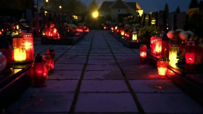 蜡烛在黑暗中闪耀的低角度视图设置了墓地的大气气氛
