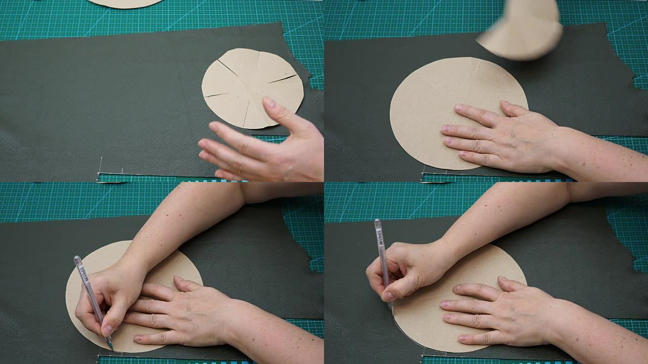 工匠使用纸质图案绘制小袋底部的切割图案