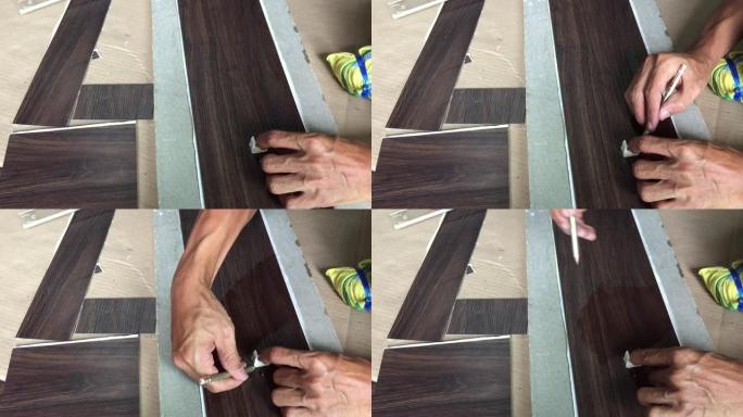 人用切刀切割地板材料