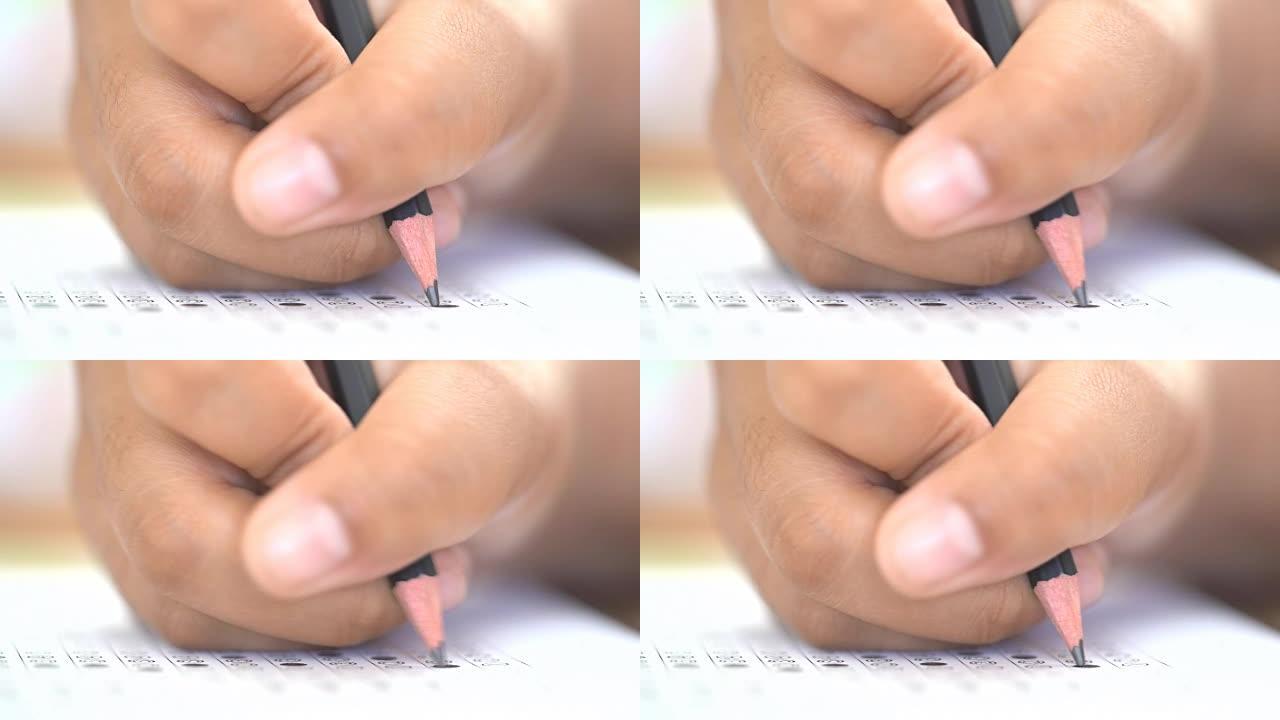 考试考试概念，考试答题纸上的特写铅笔，考试教室中学生的手笔。知识评价研究生教育评估的It多项选择