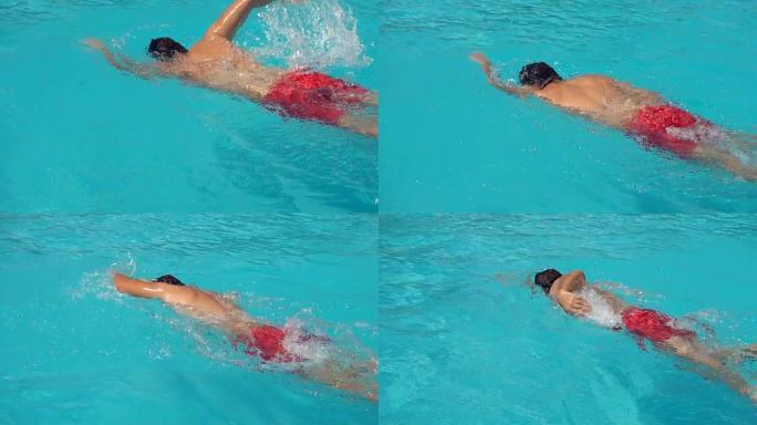 专业游泳运动员的慢动作在室外游泳池游泳