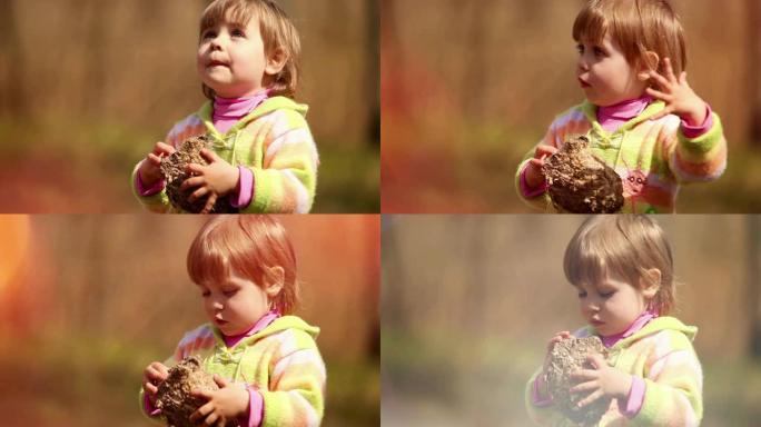 一个可爱的小女孩对她发现的一个古老的蜂巢 (黄蜂的巢) 着迷