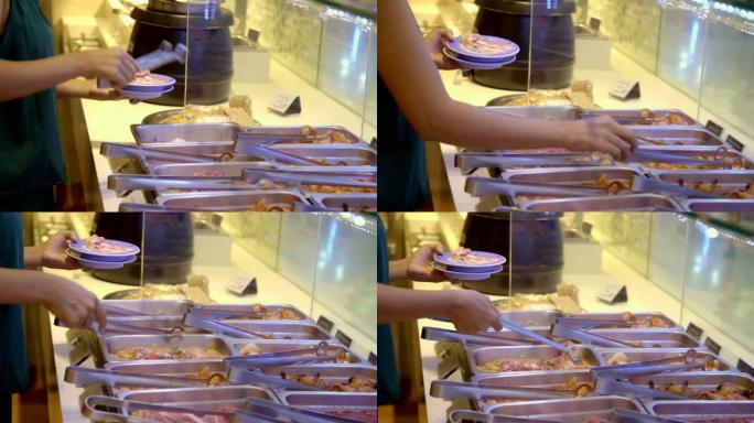 4k女人为烤肉串烧烤采摘猪肉片的镜头。
