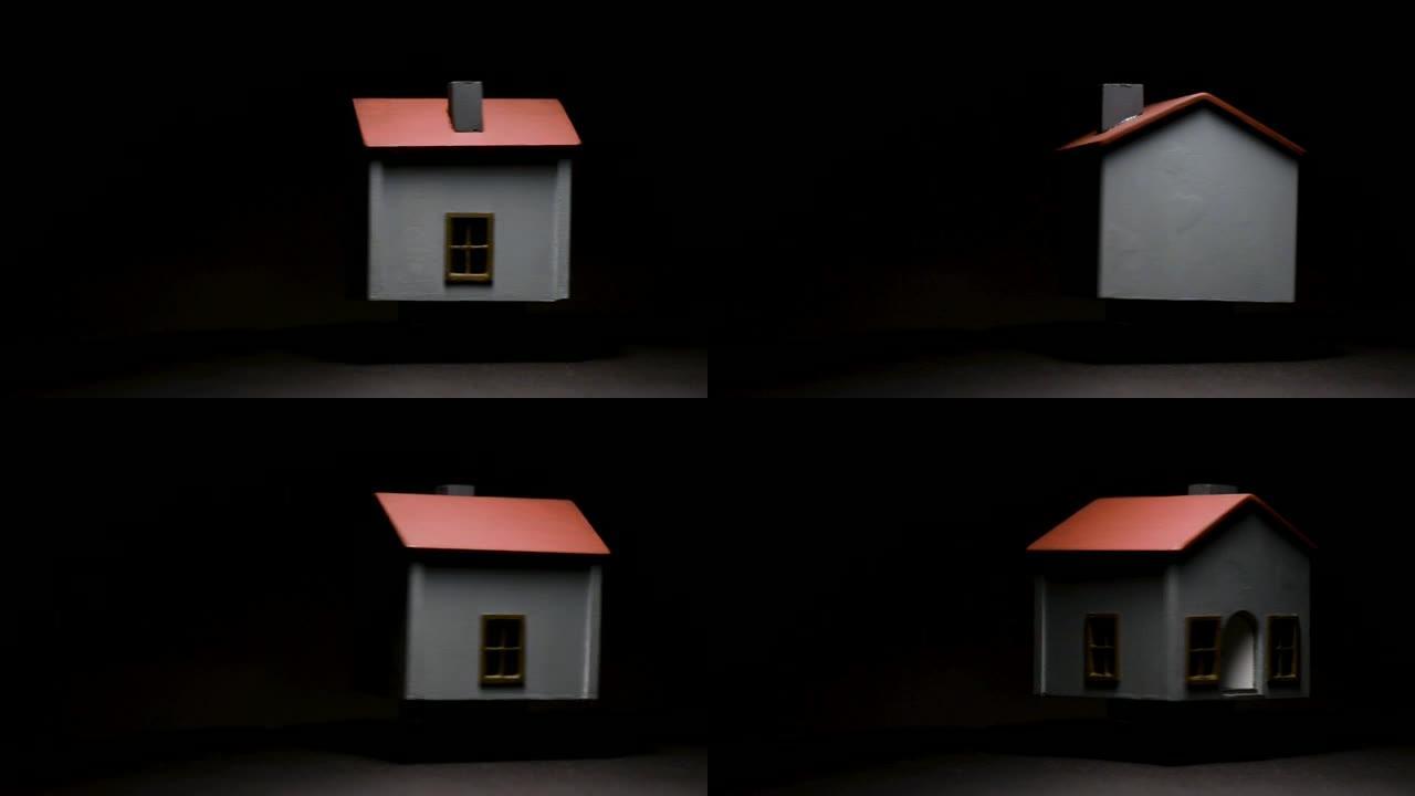 旋转模型房子在黑色背景和高对比度。