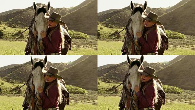 漂亮年轻的金发女牛仔领着她的马停下来挠他的鼻子