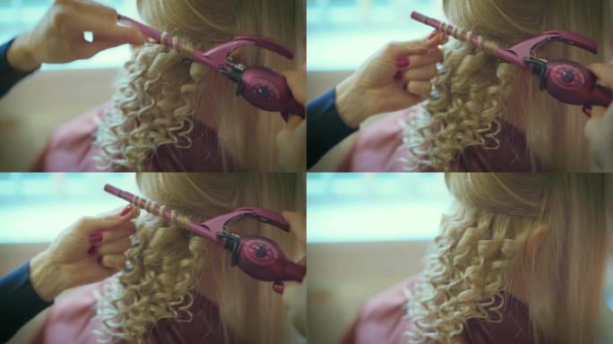 微笑的女美发师在美发沙龙为漂亮的金发美女做发型