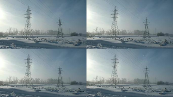 冬季的电力输电线路。高压电力挂架电线杆。