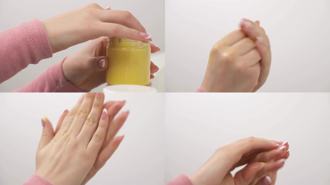 女人的手与修指甲的特写，涂抹天然黄色乳霜。平滑地移动涂抹护手霜，使其浸透。