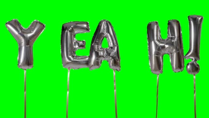 来自漂浮在绿色屏幕上的氦银气球字母的单词yeah