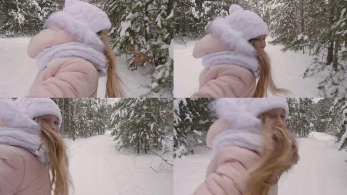 快乐的女孩手牵手穿过雪道。