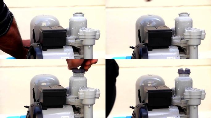 水管工将电线绑在组装用于家庭供水的水泵灌溉上，特写镜头。