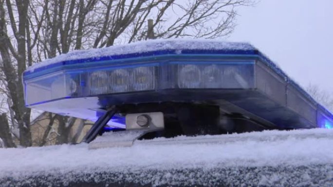 警车蓝色冲水灯在雪地里闪烁。