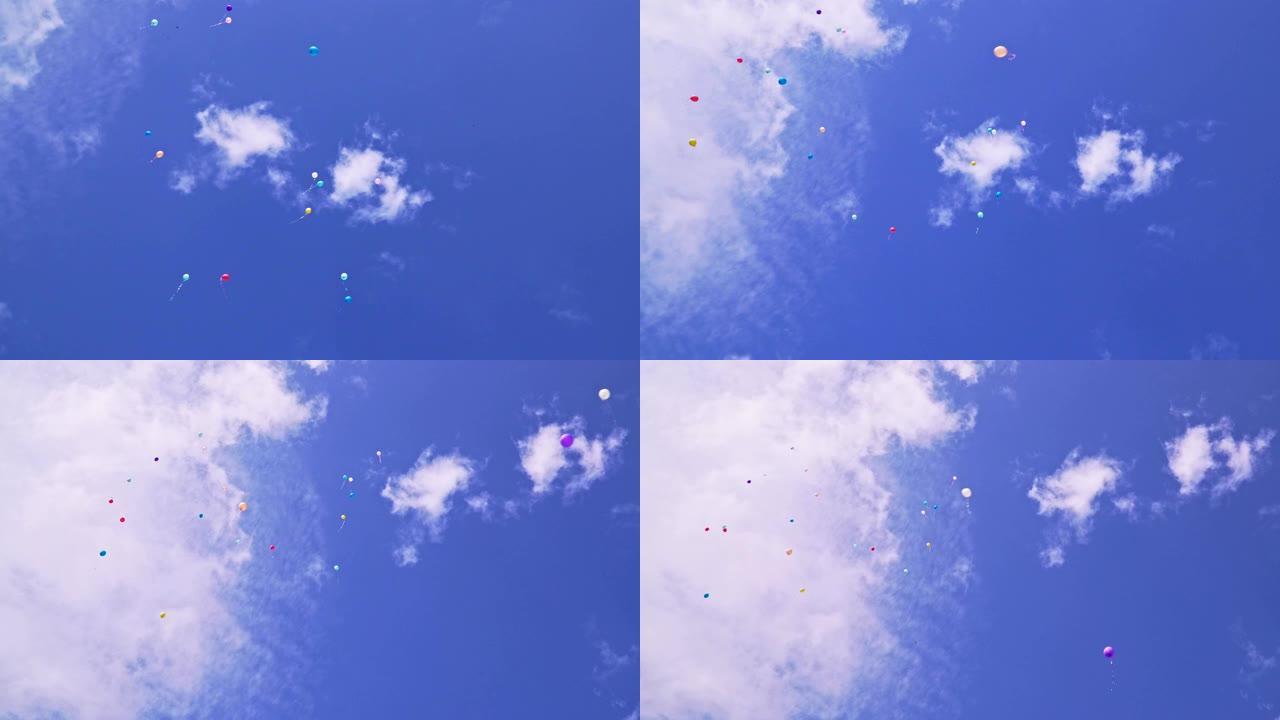 美丽的多色气球在蓝天上飞翔
