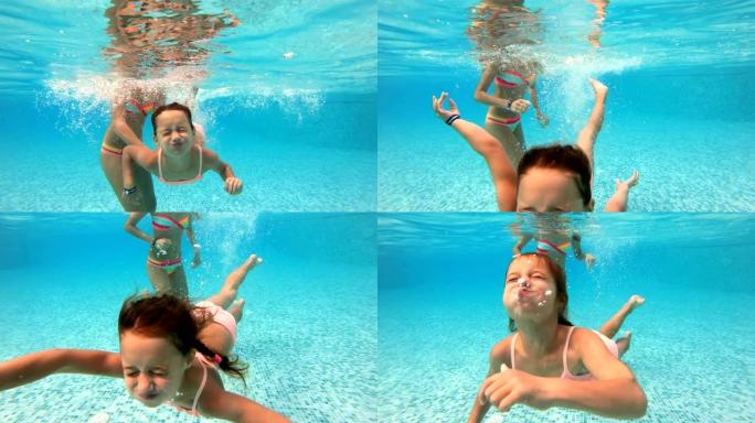 小女孩在游泳池里水下游泳。