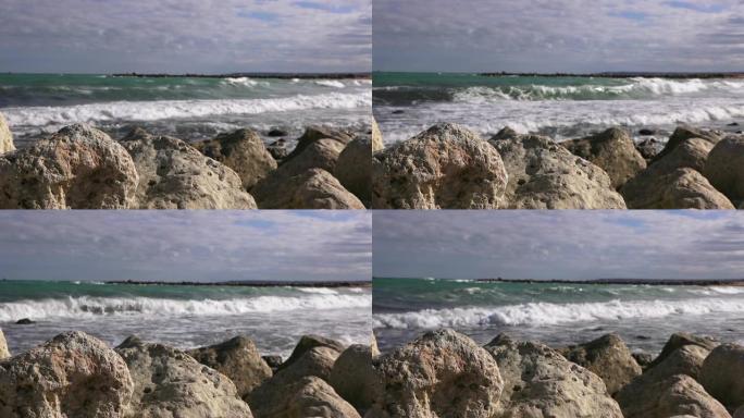 在暴风雨的海洋背景下的海石特写