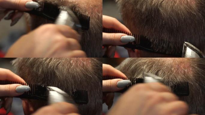 女理发师用电动理发剪男人的头发