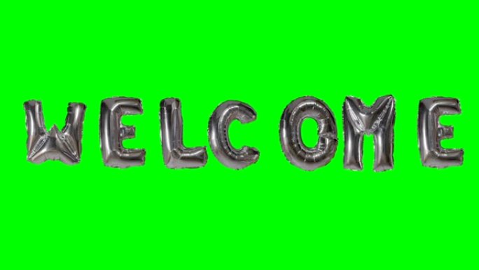 来自漂浮在绿色屏幕上的氦气银气球字母的欢迎词