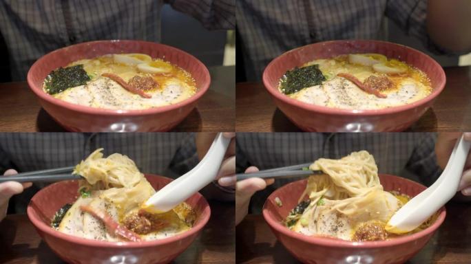 男子在咖啡馆吃日本拉面和热汤