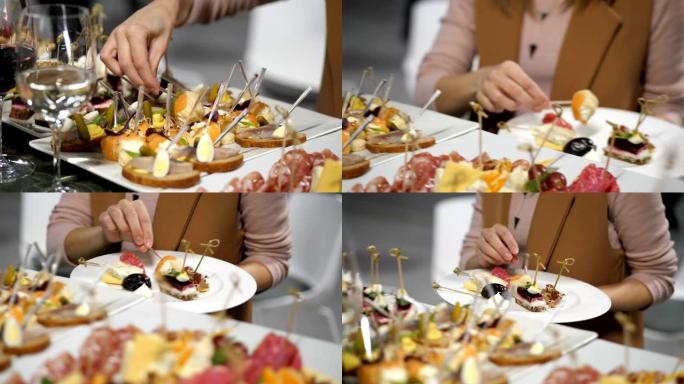 活动自助餐。一个女人在盘子上放各种小吃。4k慢速移动