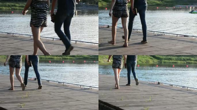 人们沿着码头走，只看得见他们的腿。
