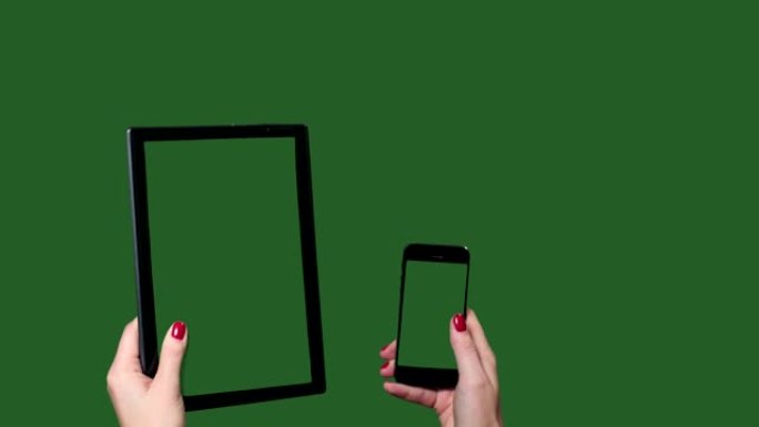 Chromakey。绿色屏幕。女性手中的平板电脑和智能手机。