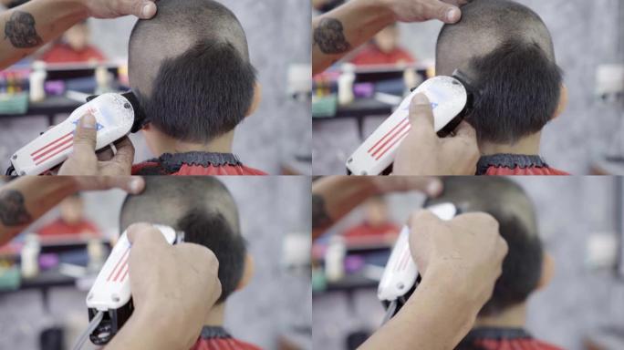 特写美发师在亚洲小男孩做发型