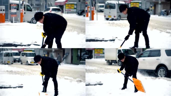 男子在冬天铲雪，而汽车在城市环境中行驶