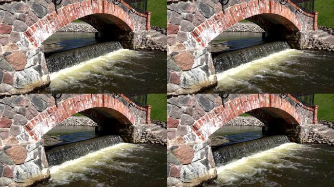 复古红砖石拱和瀑布流水。4K