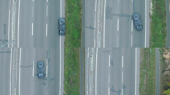 汽车的空中射击，在高速公路上。在高速公路上的复古黑色宝马的鸟瞰图