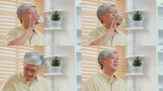 资深亚裔男子在家厨房喝牛奶，退休生活方式，活跃资深健康