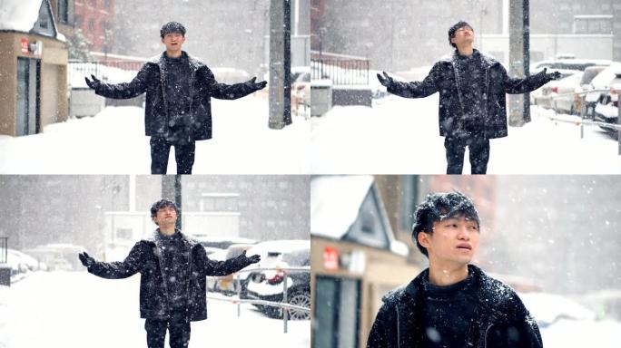 大雪-亚洲人对雪感到兴奋，微笑着站在街道中央