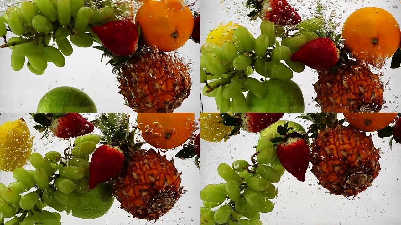 苹果，猕猴桃，橙子，梨，柠檬，葡萄，菠萝和浆果落入水中。孤立白色背景上的视频。